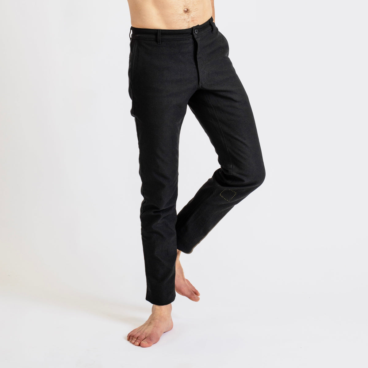 Close-up of a man wearing åäö’s Forever Pants, highlighting the crafted texture of Dyneema fabric and the perfected seams