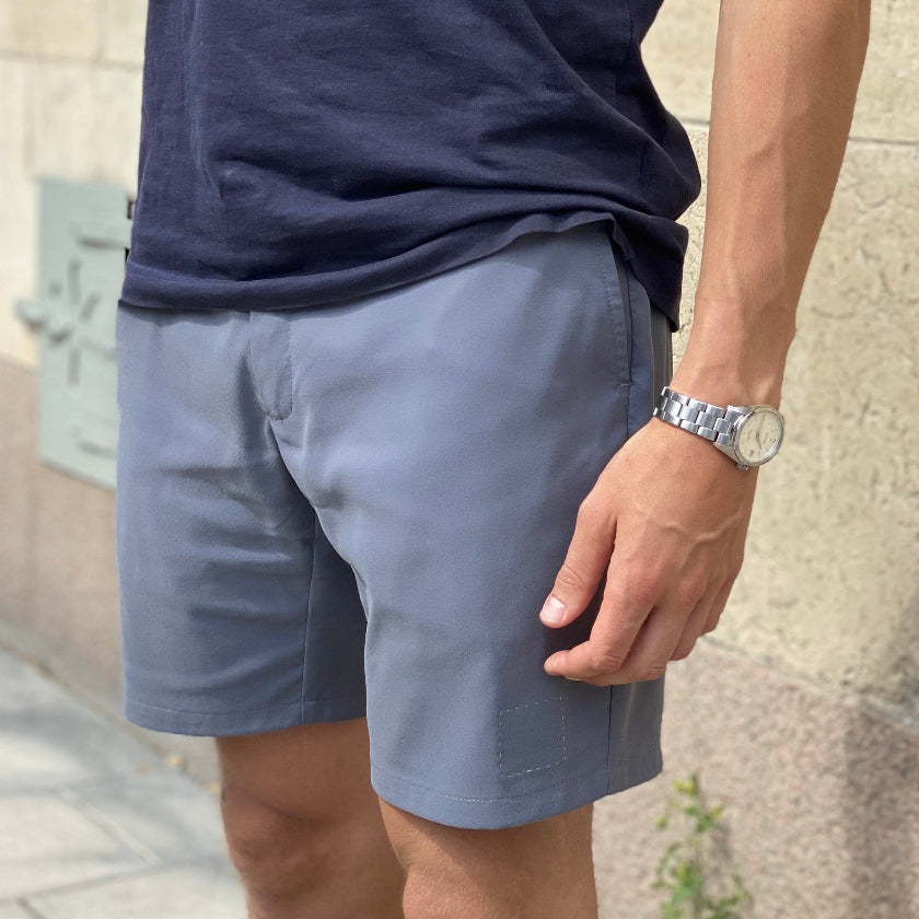 Close-up of a man wearing the Shorts by åäö in Hazy Day Blue, with the color beautifully reflecting the light.