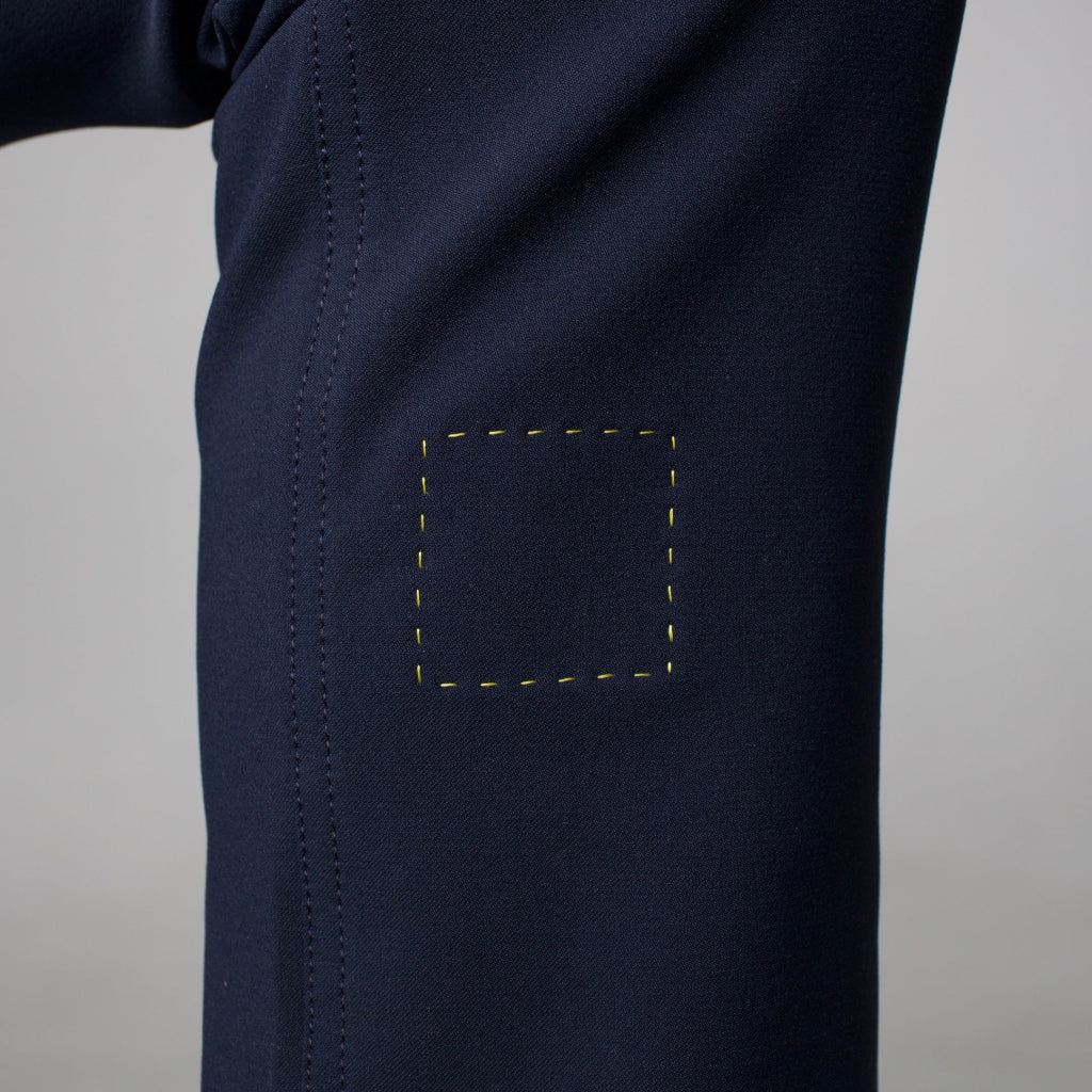 Navy blue pants with a detail on the åäö logo on a gray background