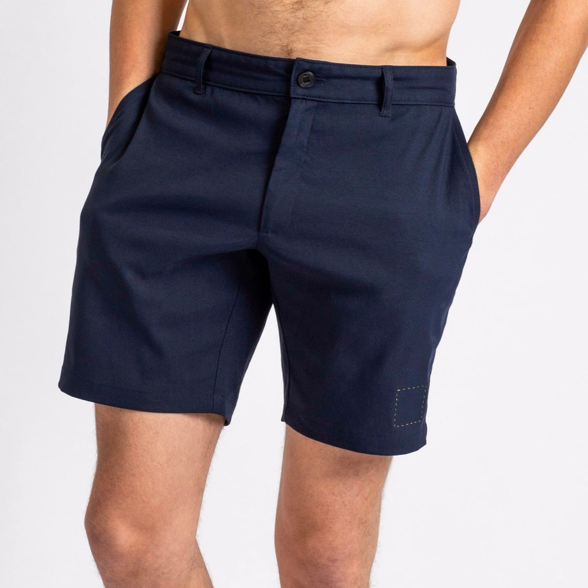 Front view of a man in åäö’s Shorts in Deep Blue, hands in pockets