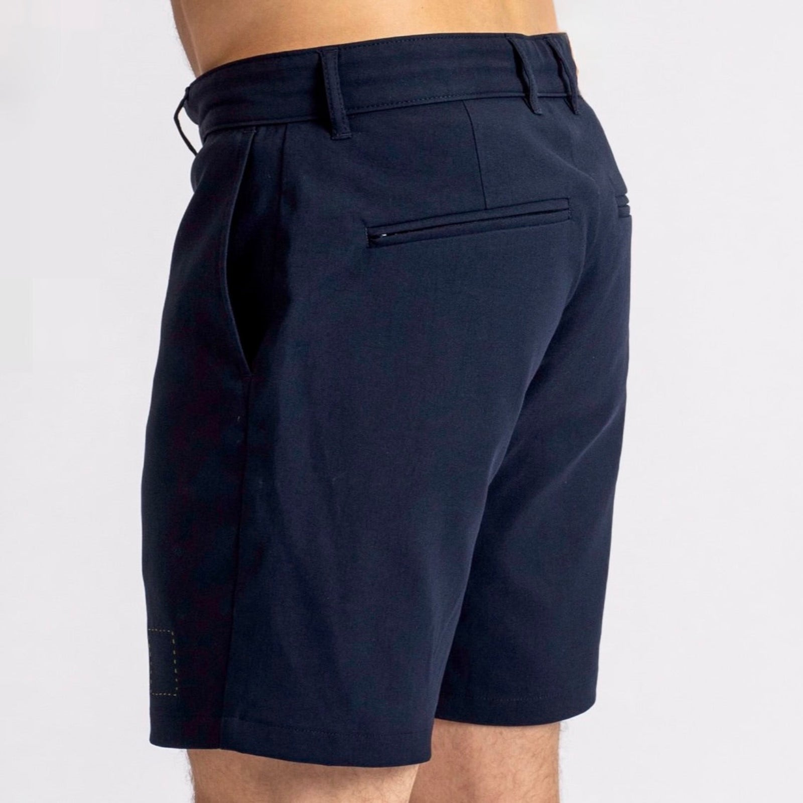Side-rear view of a man in The Shorts by åäö in Deep Blue, highlighting their perfected fit and timeless design.