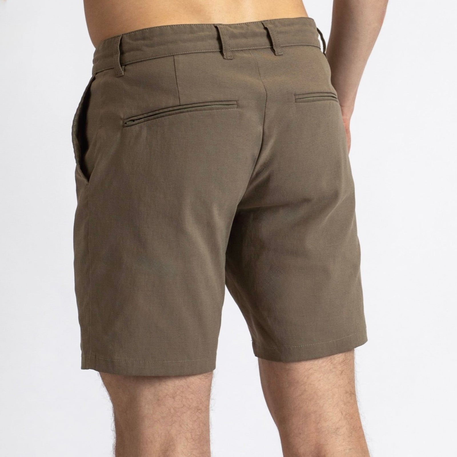 Rear view of a man in the Shorts by åäö in Dusty Desert, showcasing their timeless design.