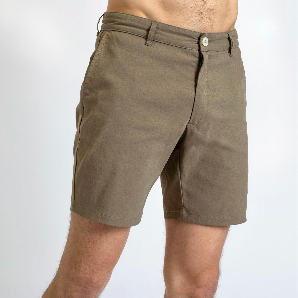 Side view of a man in the Shorts by åäö in Dusty Desert, showcasing their perfected design and timeless fit.