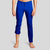 Front view of a man wearing The Pants by åäö in Brilliant Blue, rolled up slightly to highlight their versatile design.