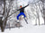 A man jumping with skis, wearing The Pants by åäö in Brilliant Blue, showcasing their dynamic fit .