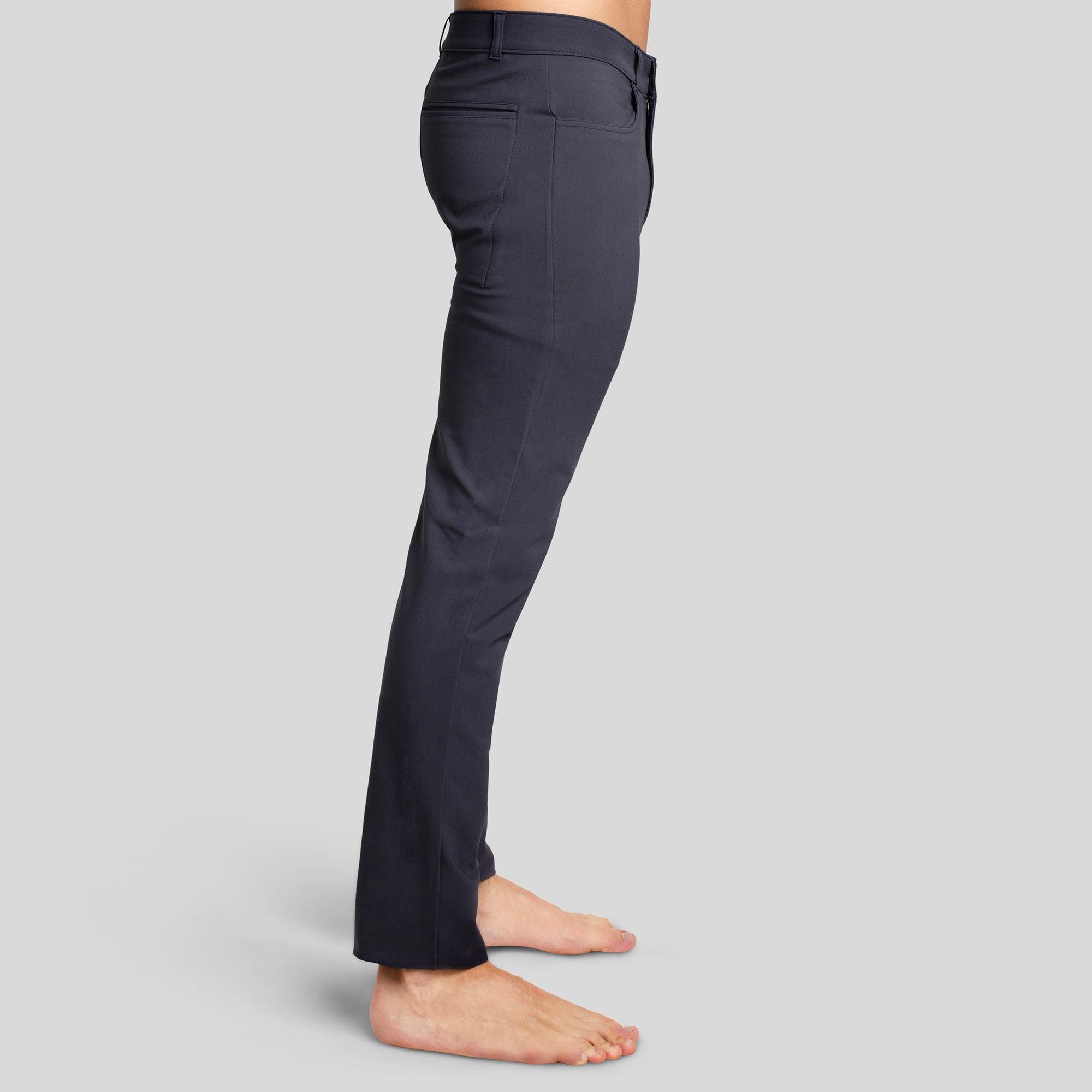 Side view of a man in The Pants by åäö in Pigeon Perfect Grey, showcasing their sleek fit and timeless design.