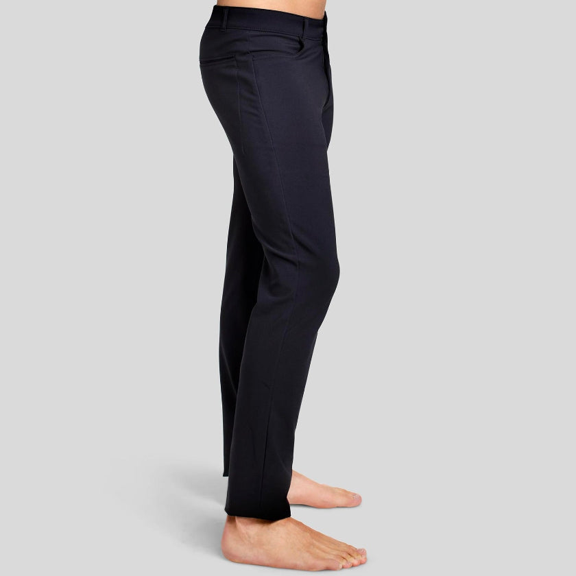 Side view of a man in The Pants by åäö in Tech Black, showcasing their sleek fit and timeless design.