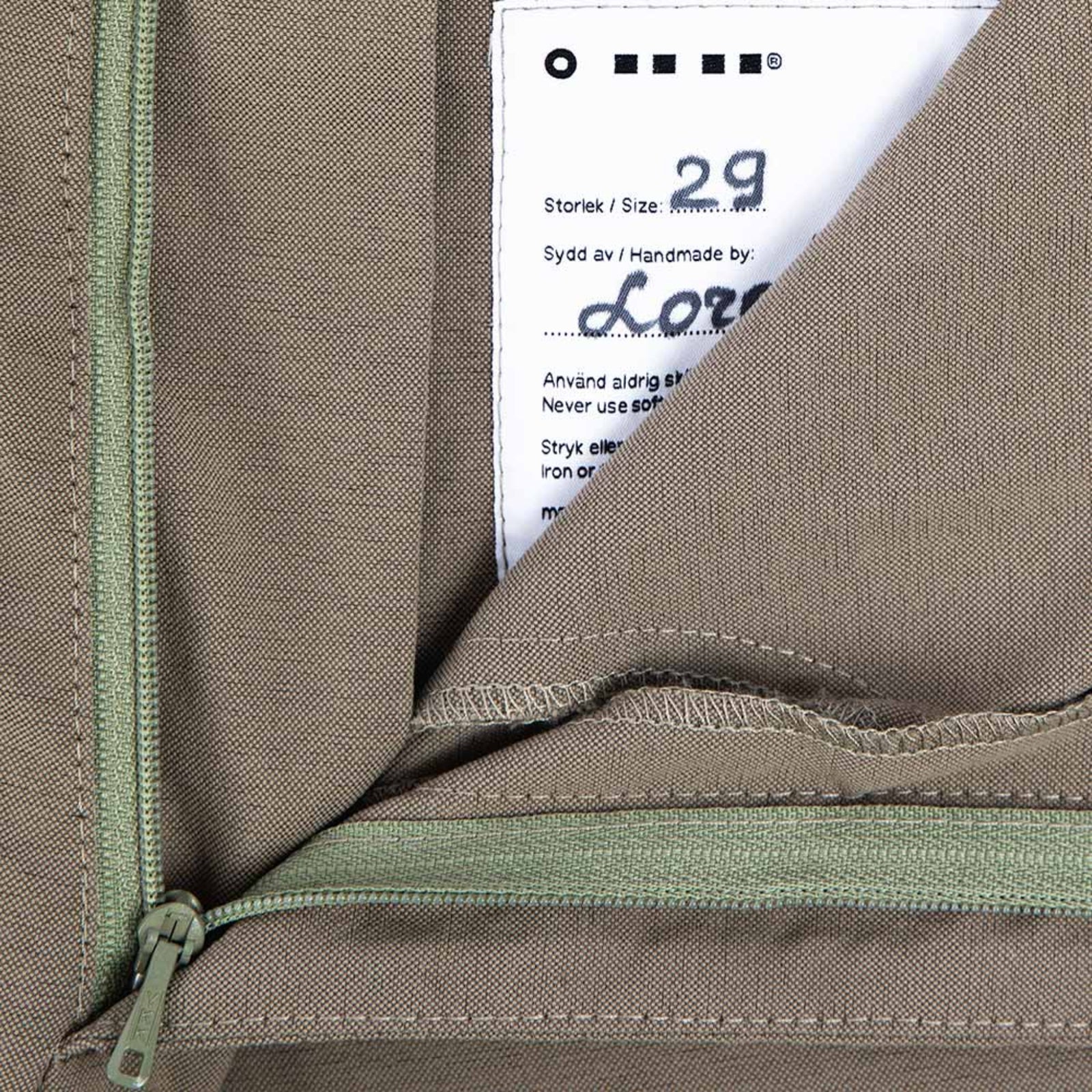 Close-up of the hand-signed size badge inside the Shorts in Dusty Desert, highlighting attention to detail and craftsmanship.