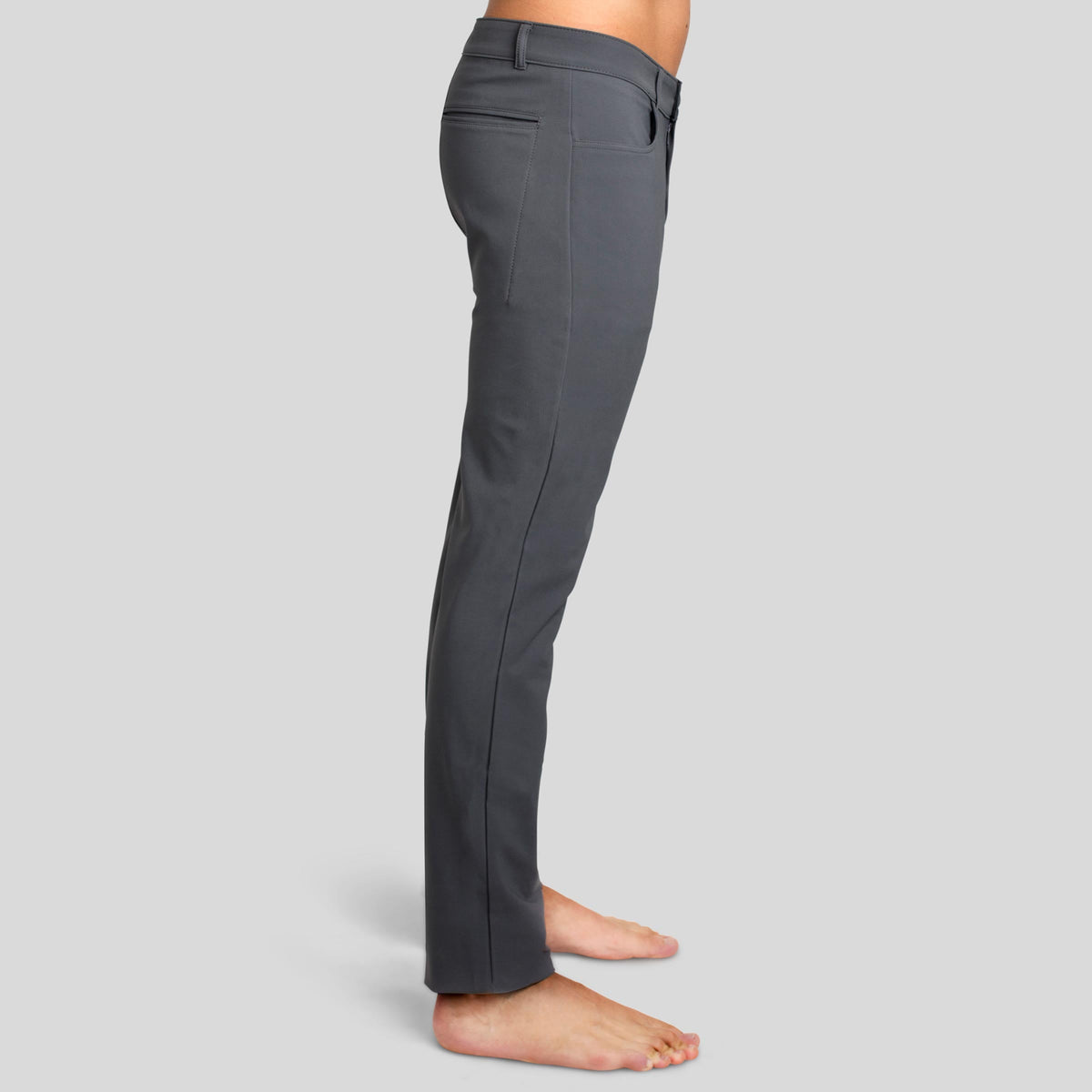 Side view of a man in The Pants by åäö in Rainy Day Grey, highlighting their sleek design and tailored fit.